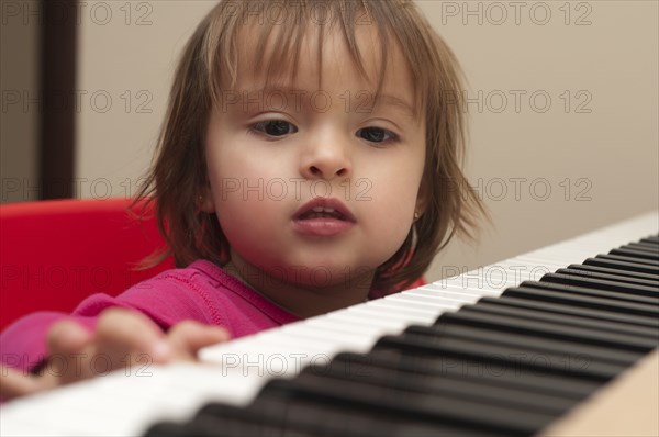 Hispanic girl playing piano