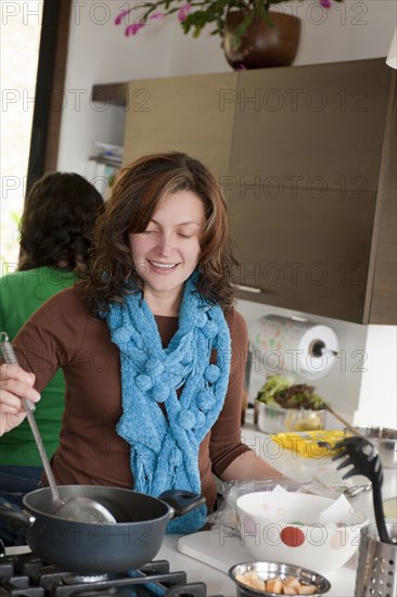 Hispanic family cooking in kitchen