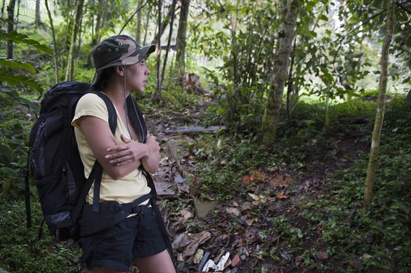 Hispanic woman hiking in forest