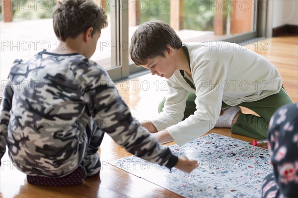 Hispanic boys playing board game