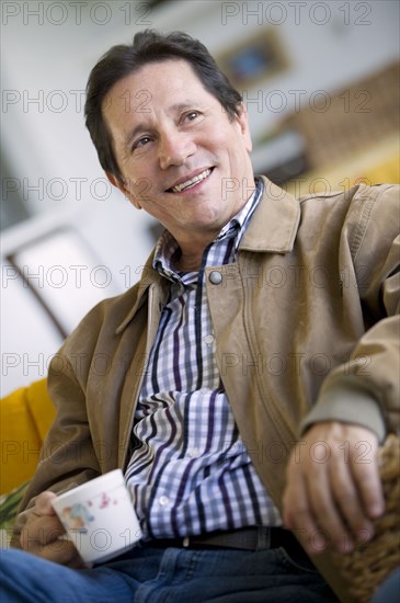 Hispanic man drinking coffee