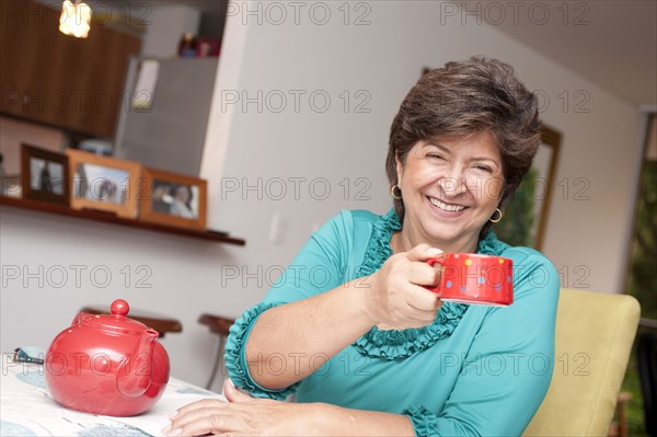 Hispanic woman drinking tea