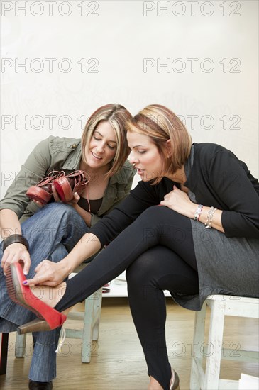 Hispanic friends trying on shoes