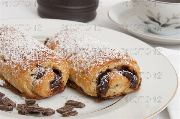 Powdered sugar on chocolate croissants