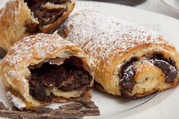 Powdered sugar on chocolate croissants