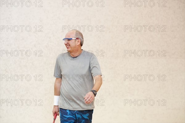 Hispanic man playing racquetball