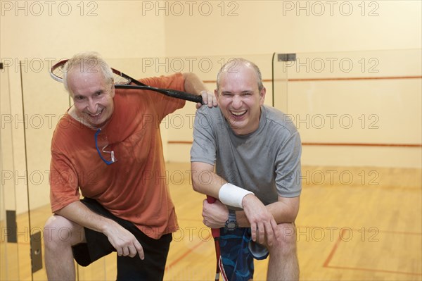 Hispanic men relaxing after racquetball