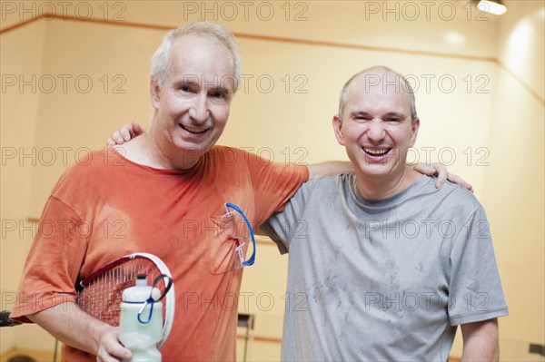 Hispanic men relaxing after racquetball