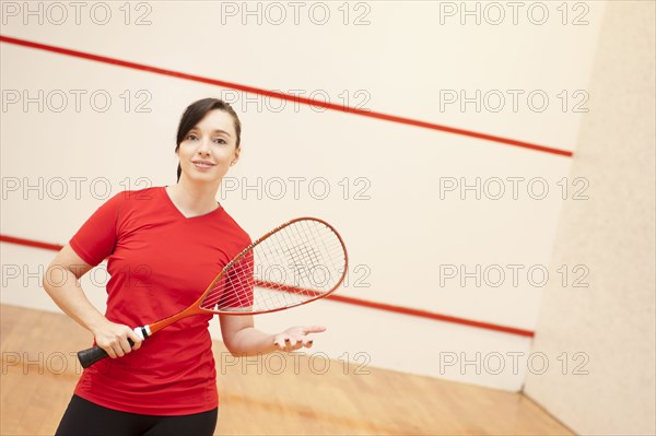 Hispanic woman playing racquetball
