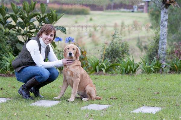 Hispanic woman petting dog