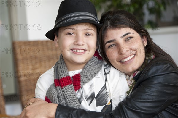 Hispanic mother hugging son