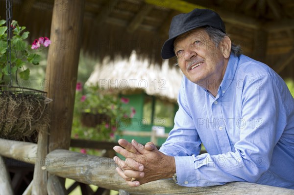 Hispanic man leaning on railing