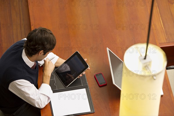 Hispanic businessman using digital tablet