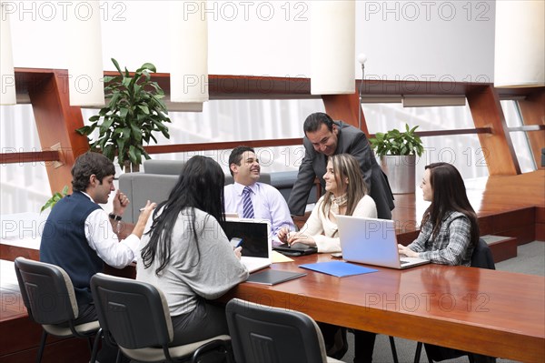 Hispanic business people having meeting in conference room