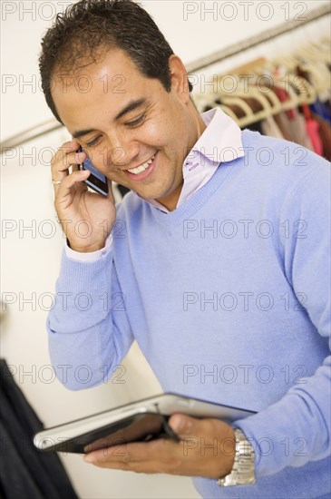 Hispanic man working in clothing store