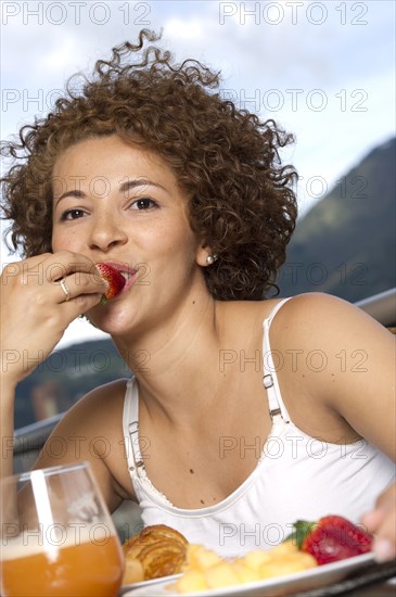 Hispanic woman eating breakfast