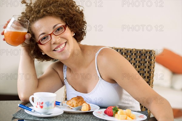 Hispanic woman eating breakfast