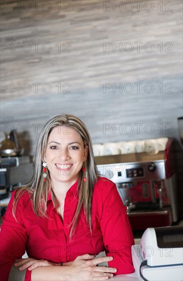 Smiling Hispanic woman in cafe