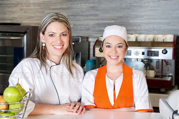 Smiling Hispanic workers in cafe