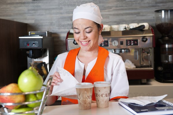 Hispanic woman working in cafe