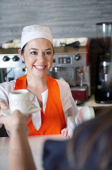 Hispanic woman working in cafe