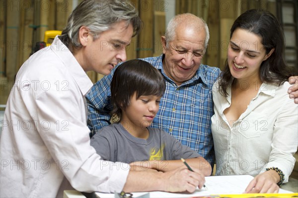 Hispanic family in carpentry workshop