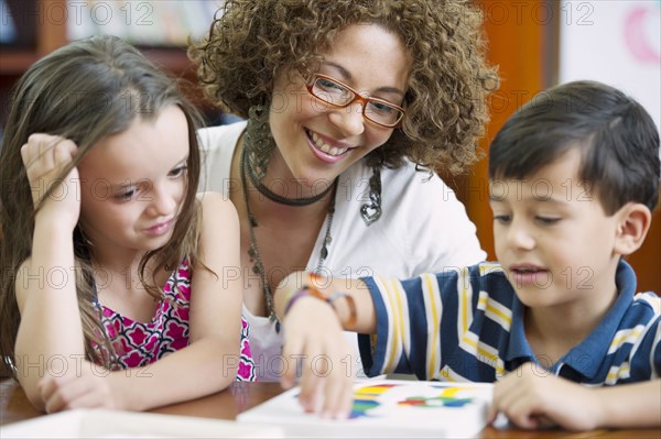 Hispanic teacher helping students