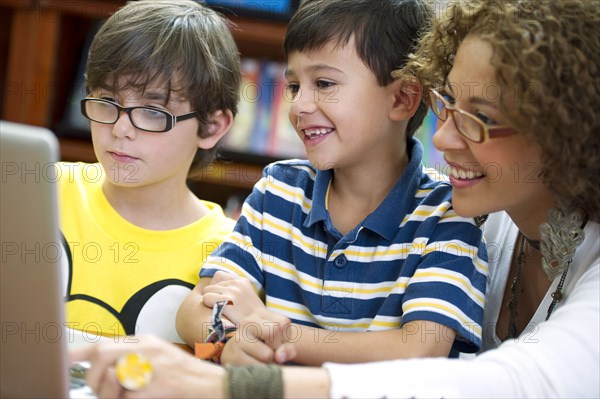 Hispanic teacher helping students