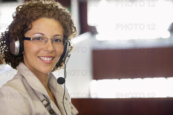 Hispanic woman listening to headphones