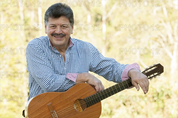 Hispanic man holding guitar