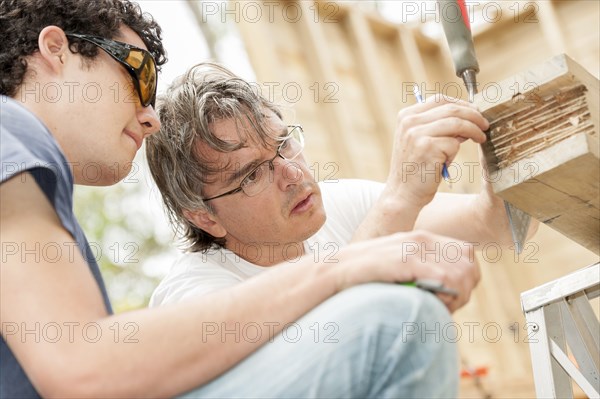 Hispanic carpenters working with wood
