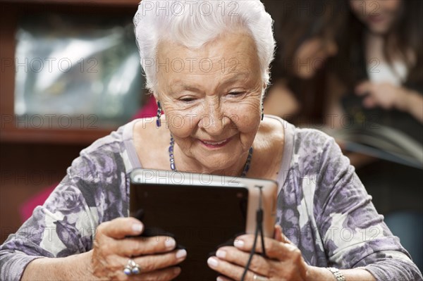 Hispanic woman using digital tablet