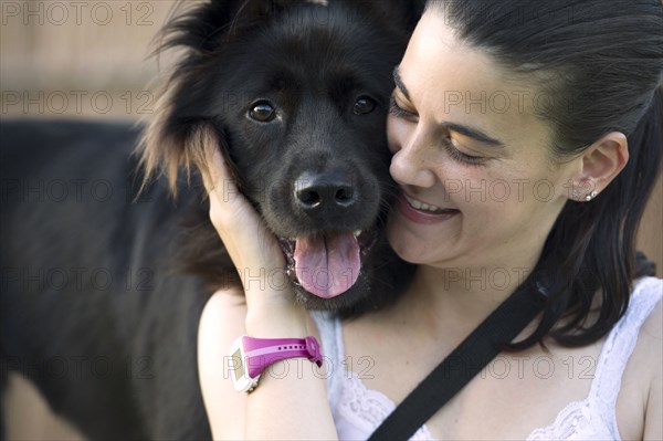 Hispanic woman petting dog