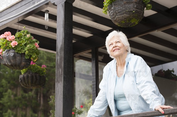 Hispanic woman standing on porch