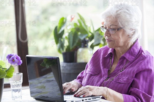 Hispanic woman using laptop