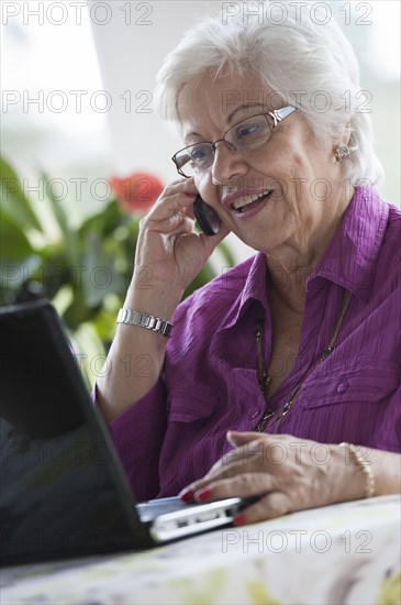 Hispanic woman using laptop