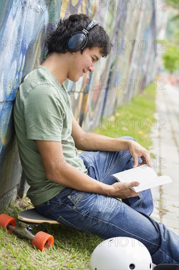 Hispanic man listening to headphones