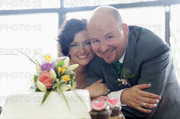 Hispanic couple smiling at wedding