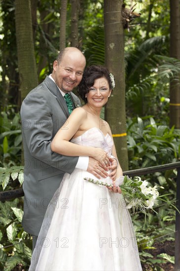 Hispanic newlywed couple smiling