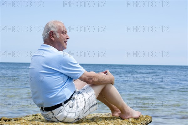 Hispanic man relaxing on beach