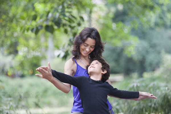 Hispanic mother and son playing outdoors