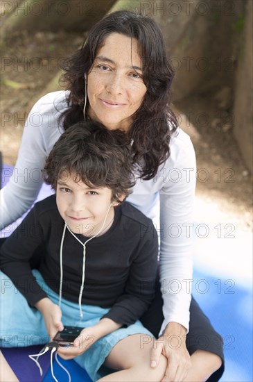 Hispanic mother and son listening to mp3 player