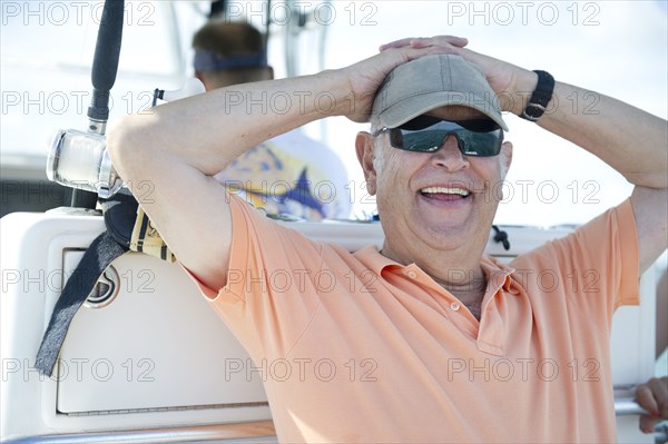 Hispanic man fishing in boat