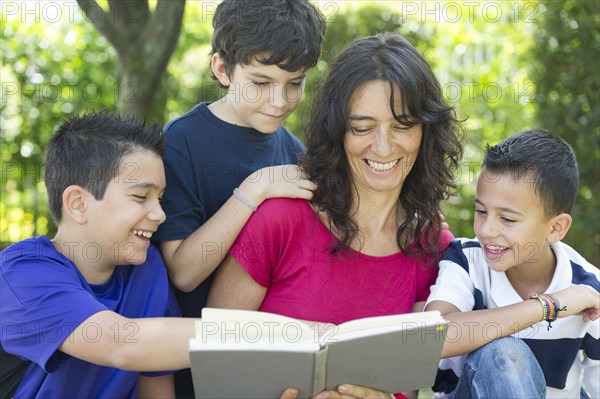 Hispanic family reading book