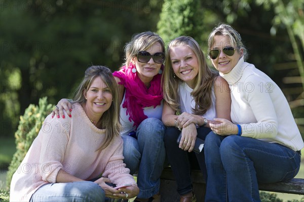 Smiling friends posing outdoors