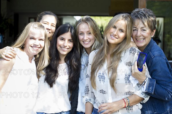 Smiling women posing at family reunion