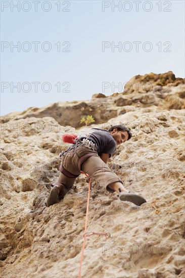 Argentinean man rock climbing