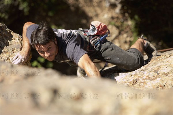 Argentinean man rock climbing