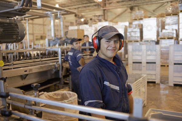 Hispanic man working in bottling factory