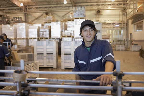 Hispanic man working in bottling factory